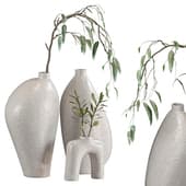 a vase with an olive branch